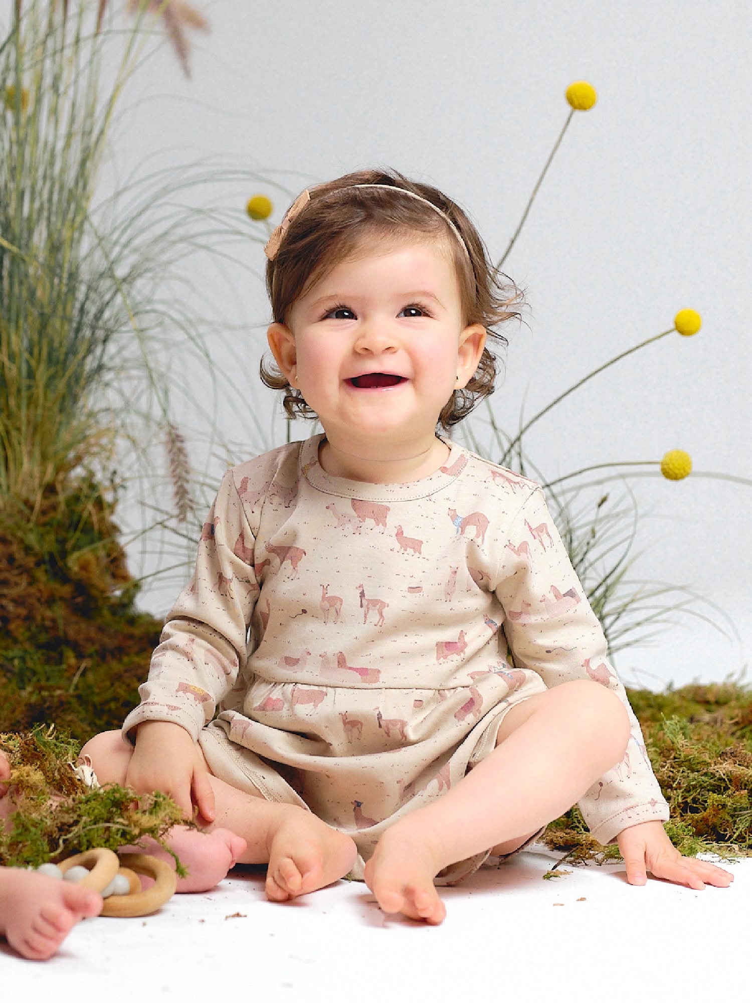 Beige alpaca print dress with long sleeves.