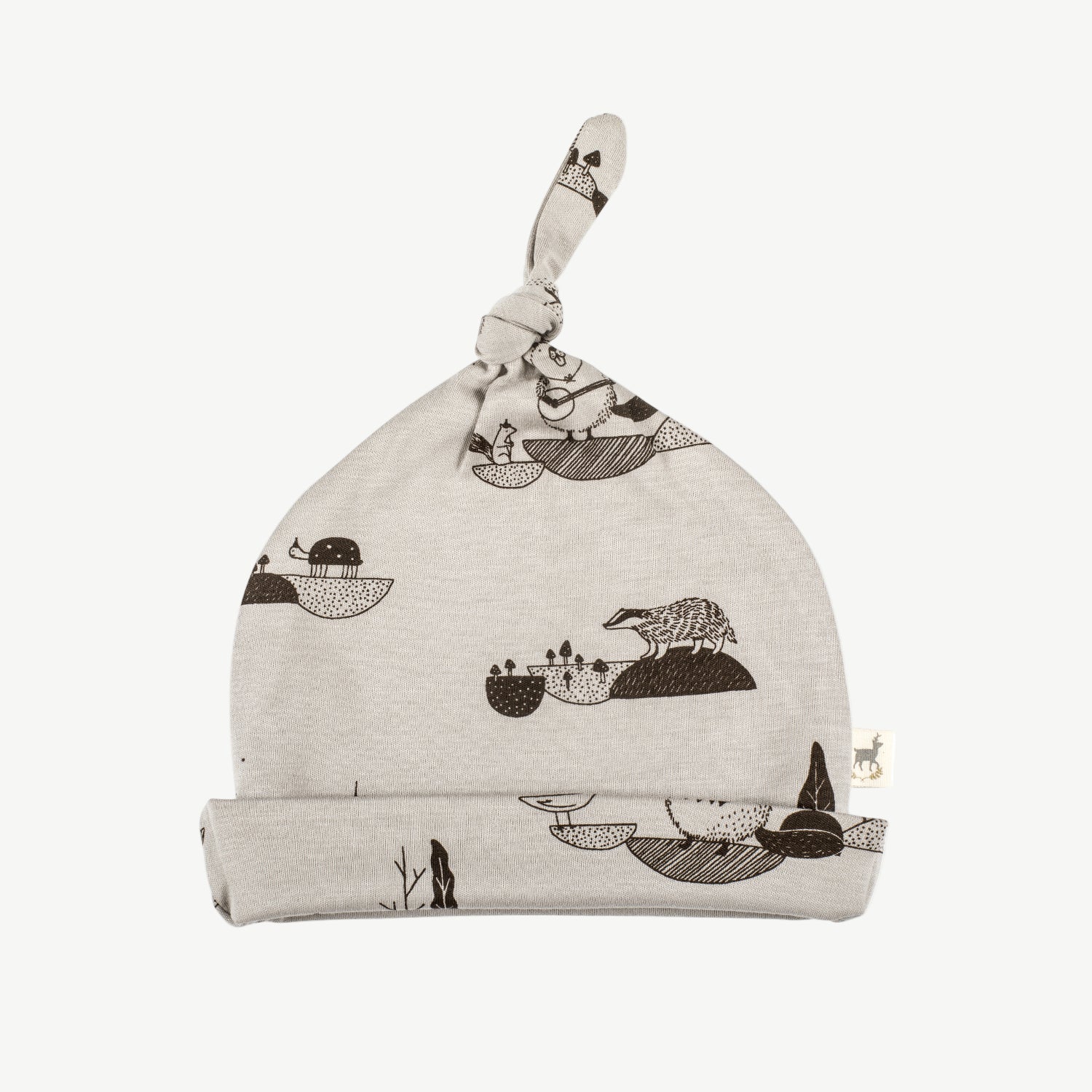 A grey knotted beanie with a pattern featuring whimsical characters.