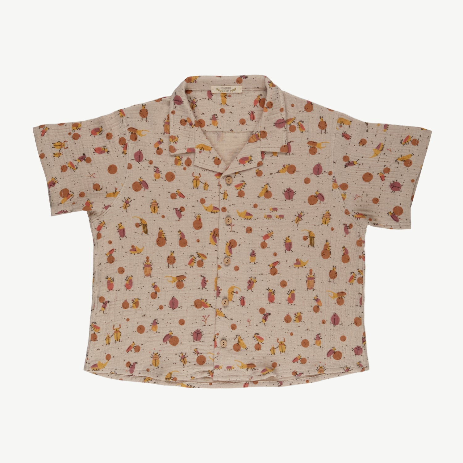 A beige muslin fabric shirt with a floral pattern and wooden buttons, displayed on a white background.