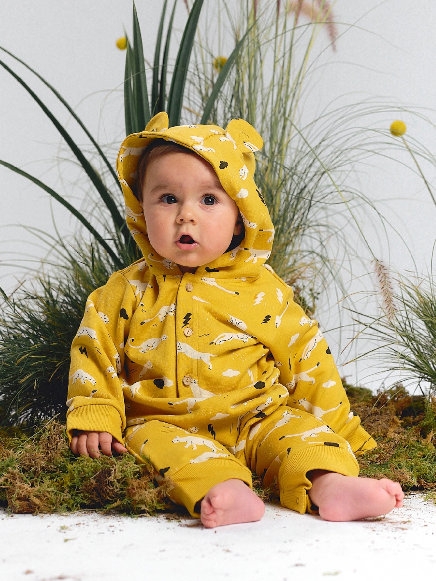 Yellow hooded jumpsuit with puma print and little bear ears.