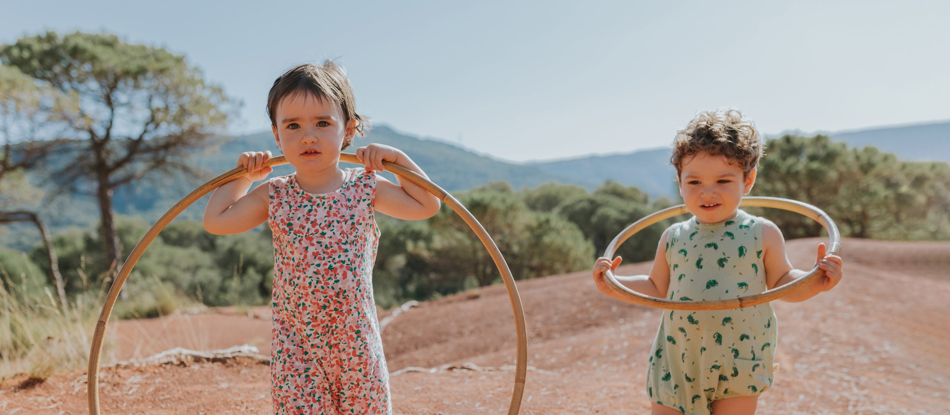 Red Caribou SS25 Collection - Sustainable baby clothing made from organic cotton, featuring warm tones and nature-inspired prints.