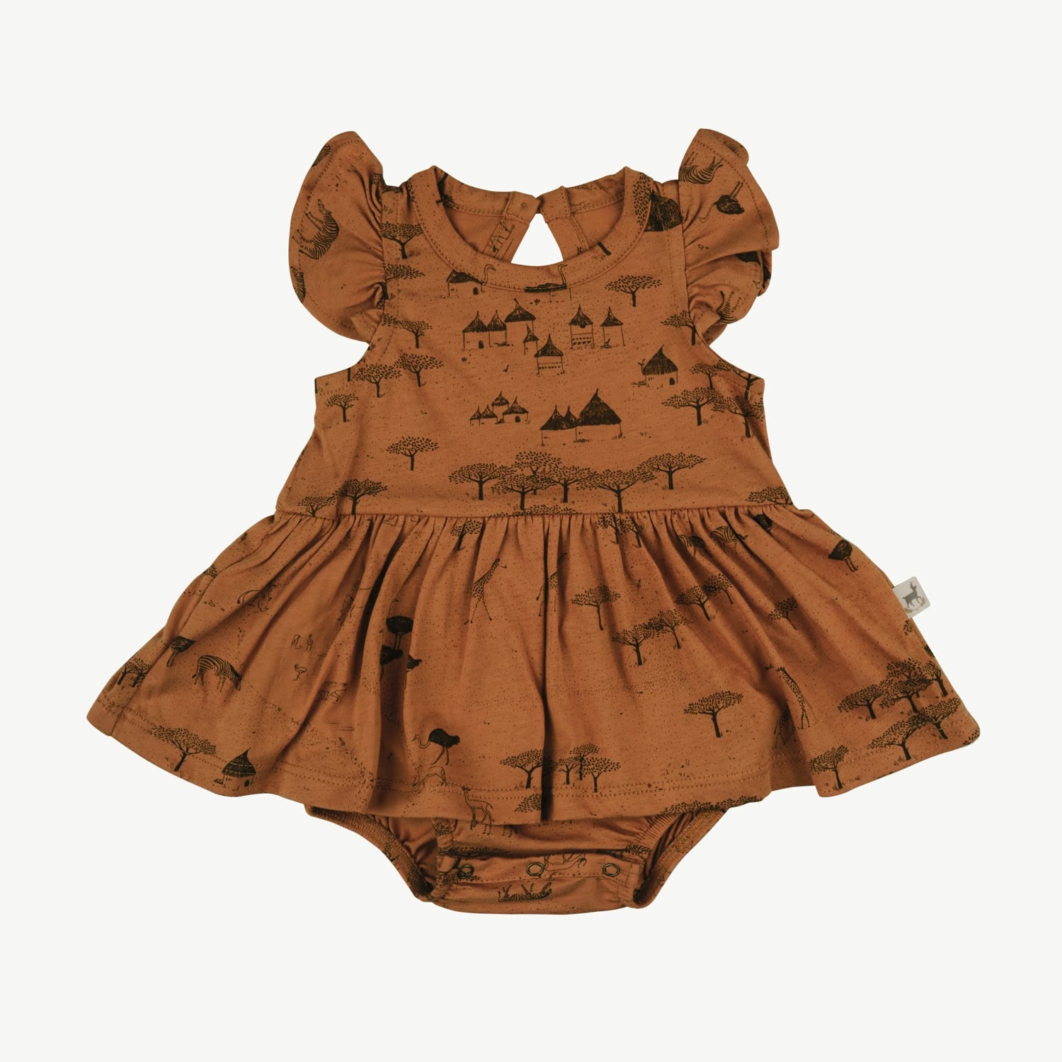 Baby onesie dress with frill sleeves in rust organic cotton, featuring a black village and tree print, back button keyhole closure, and integrated bloomer with snap buttons.
